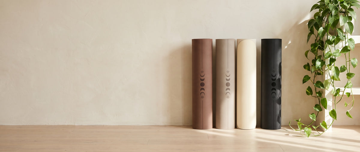 Lavafor mats in mocha, oat, cream and black leaning against a cream wall